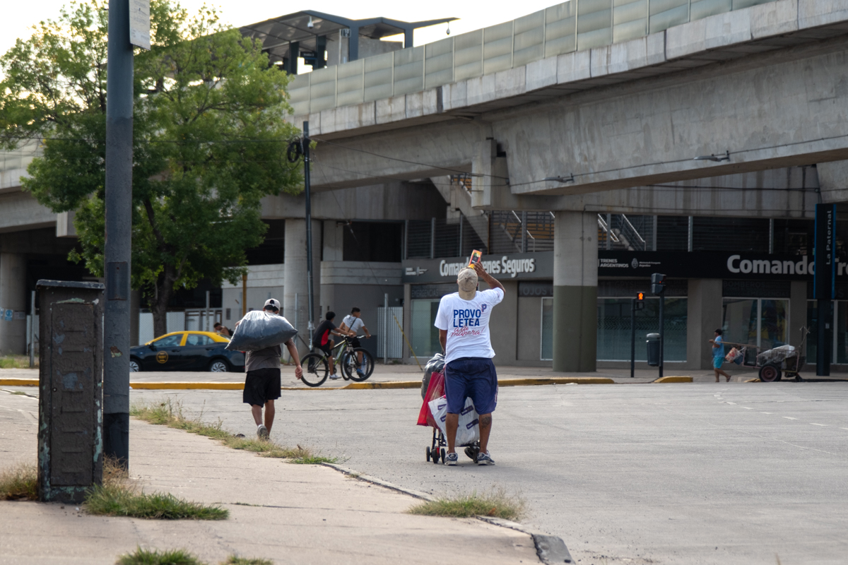 Cartonero workers sorting recyclable materials on a conveyor belt at a Buenos Aires cooperative