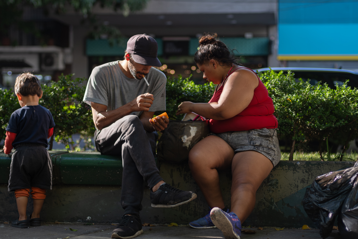 Portrait of a cartonero standing beside his loaded carro in Buenos Aires