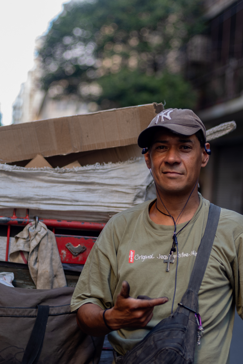 Cartonero pulling his carro through a quiet residential street at dusk, Buenos Aires