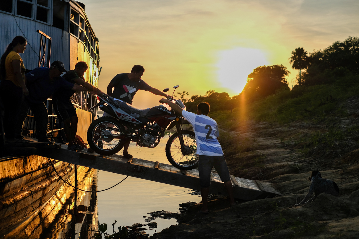 Front view of the Aquidaban moored at dusk with crew members gathered on the lower deck, Río Paraguay