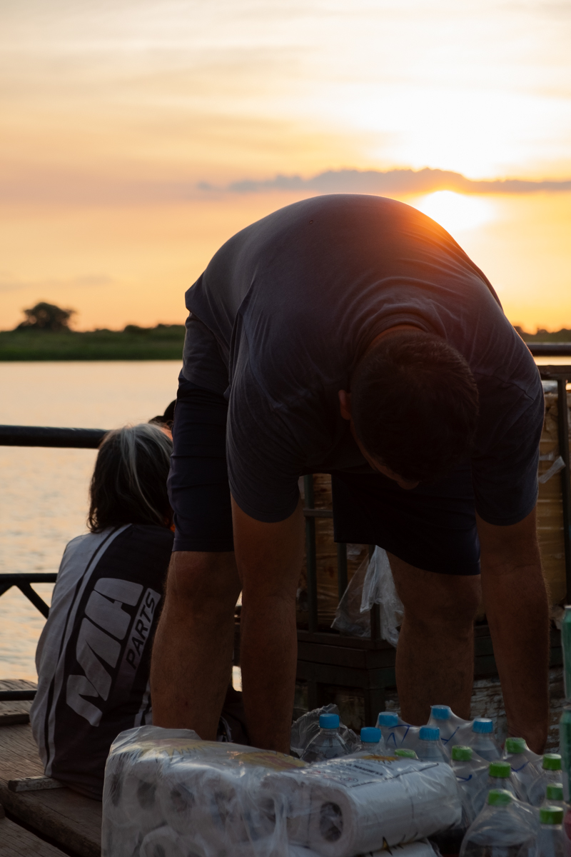 Dockers loading heavy sacks onto the Aquidaban via a wooden gangplank at a river port, Paraguay