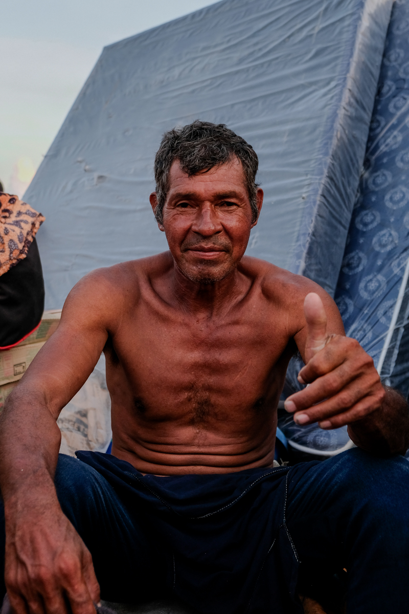 Wide shot of the Aquidaban moored beside a beached vessel at a remote Pantanal port, Paraguay