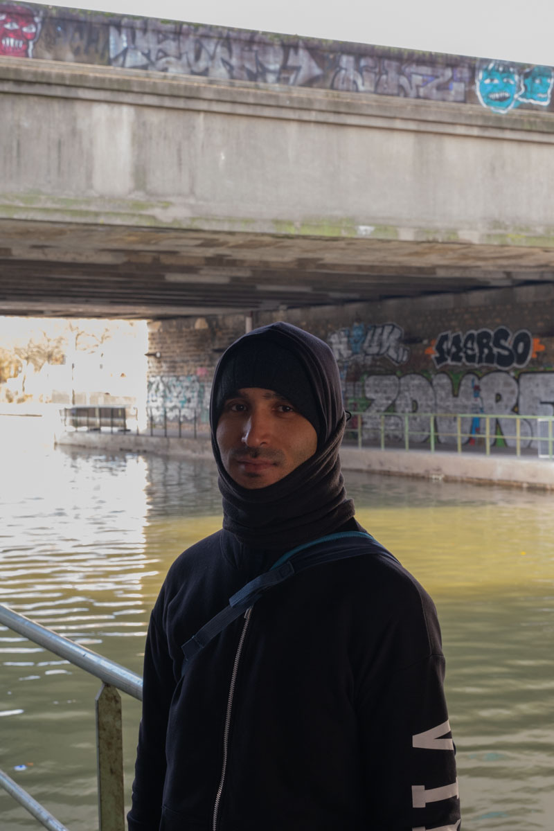 Oversized colourful plant pots with benches on a suburban Paris square, used as hostile urban furniture